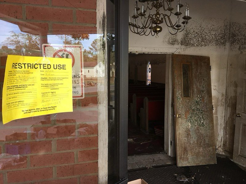 County restricted-use notice on a flood-damaged Pender County building after Hurricane Florence