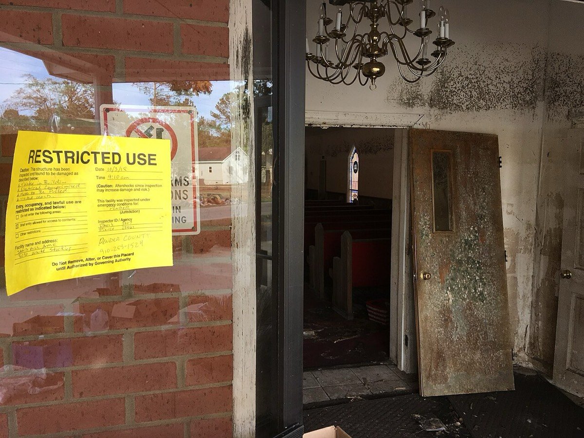 County restricted-use notice on a flood-damaged Pender County building after Hurricane Florence